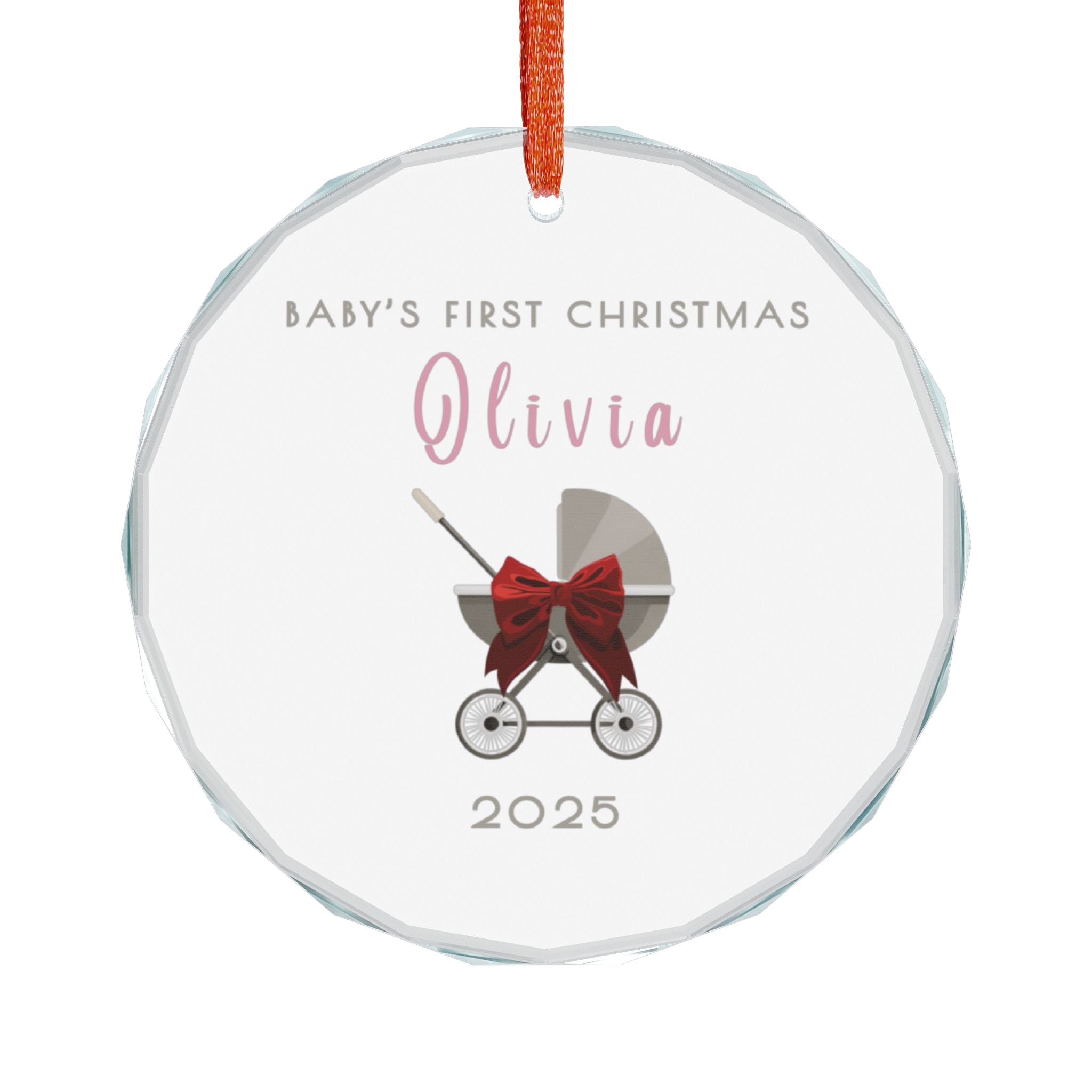 Round crystal glass Christmas ornament featuring a baby carriage (pram) design accented with a red bow. Personalised text includes the baby's name, the year, and the phrase "Baby's First Christmas". 