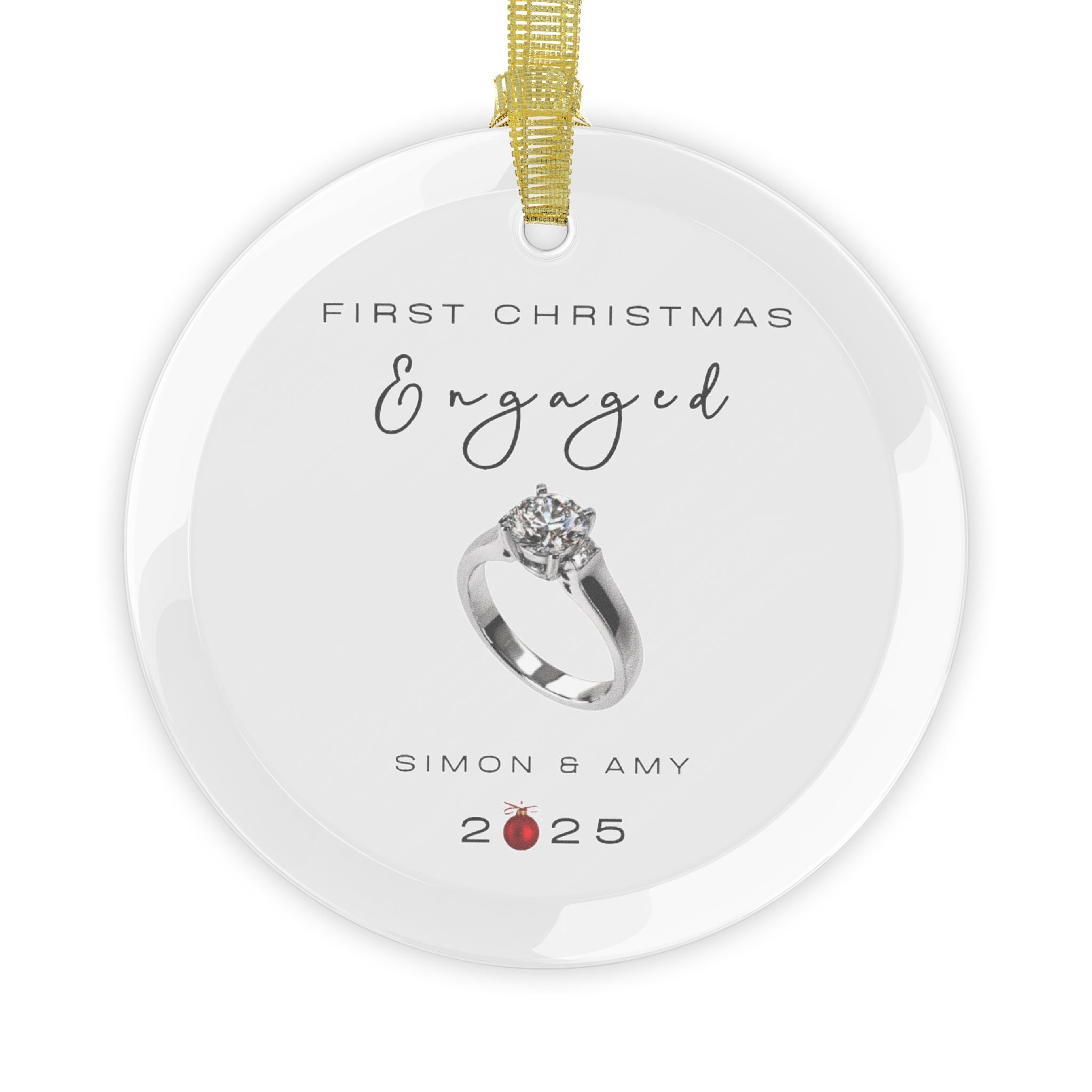 Round glass Christmas ornament featuring an engagement ring and the text "First Christmas Engaged" followed by personalised names and the year. 