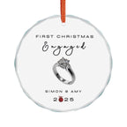 Round crystal glass Christmas ornament featuring an engagement ring and the text "First Christmas Engaged" followed by personalised names and the year. 
