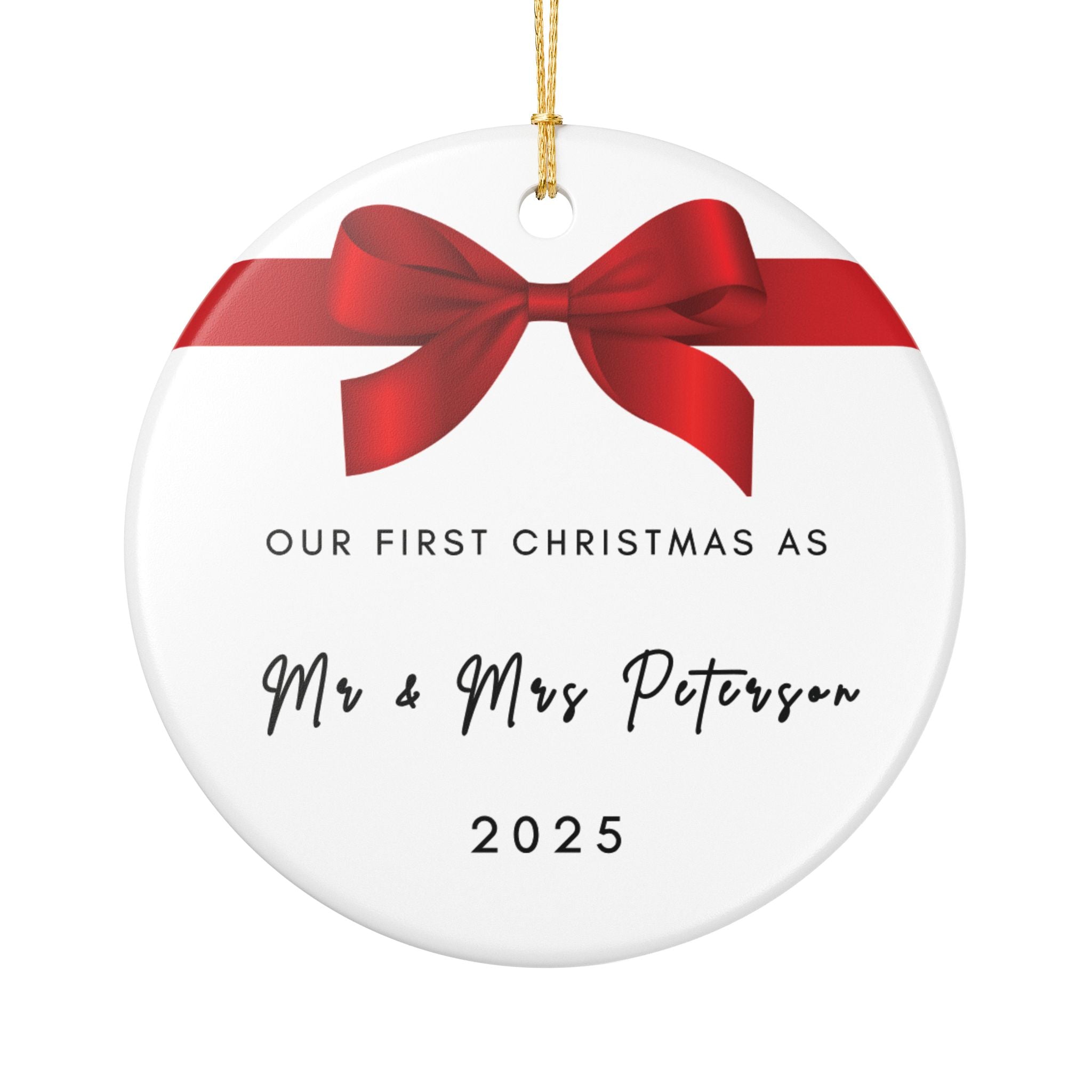 Round ceramic Christmas ornament featuring a red bow and the text "Our First Christmas As Mr & Mrs" followed by a personalised surname and the year.