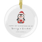 A round glass Christmas ornament featuring an illustrated penguin wearing a Santa hat. It displays custom text that begins, "Happy 1st Christmas as My," followed by a personalised grandparent title, name and custom message.