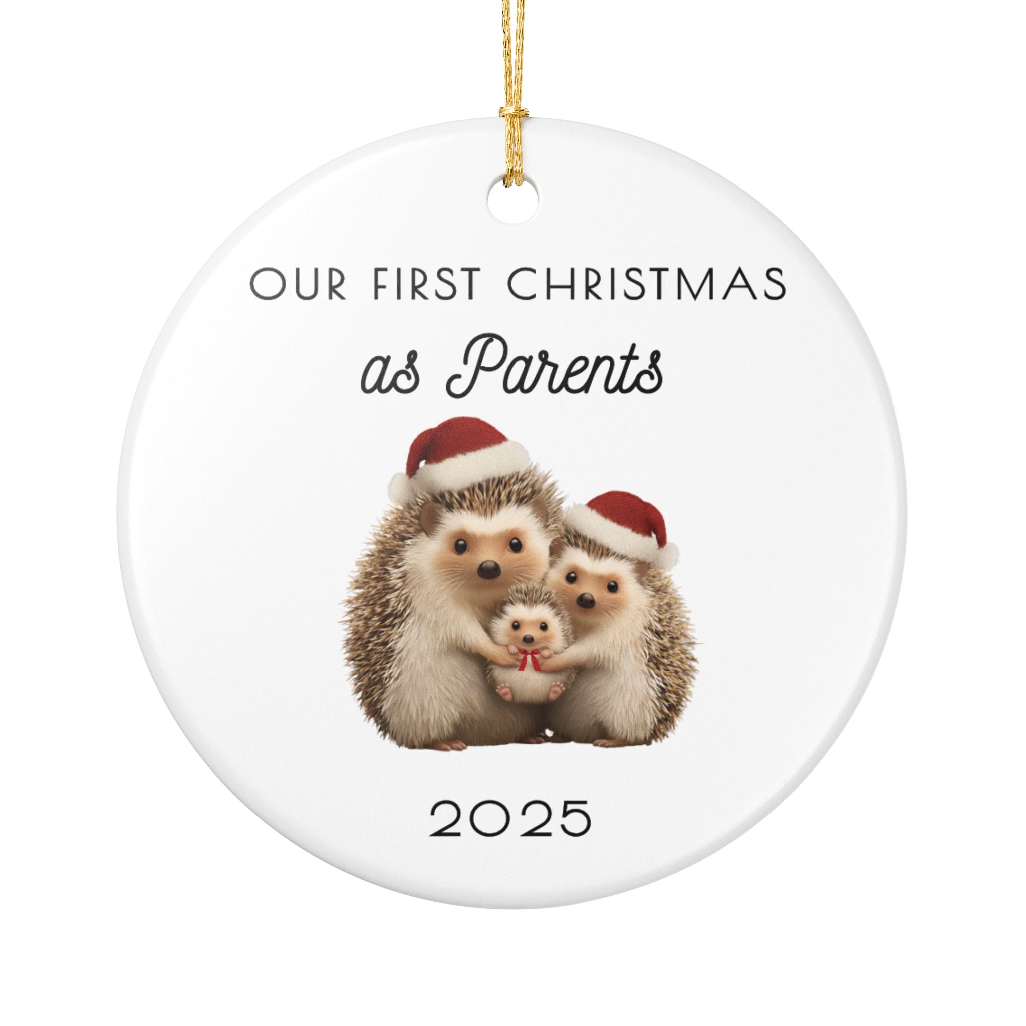 Decorative ceramic Christmas ornament with three hedgehogs wearing Santa hats and text 'Our First Christmas as Parents 2025' on a white background.