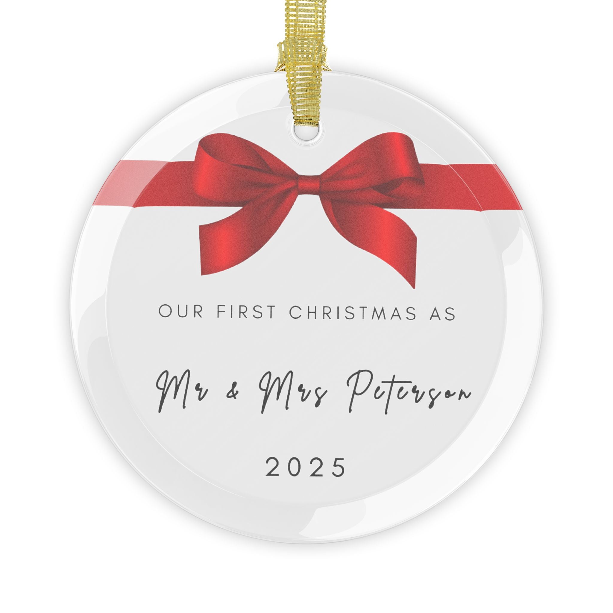 Round glass Christmas ornament featuring a red bow and the text "Our First Christmas As Mr & Mrs" followed by a personalised surname and the year.