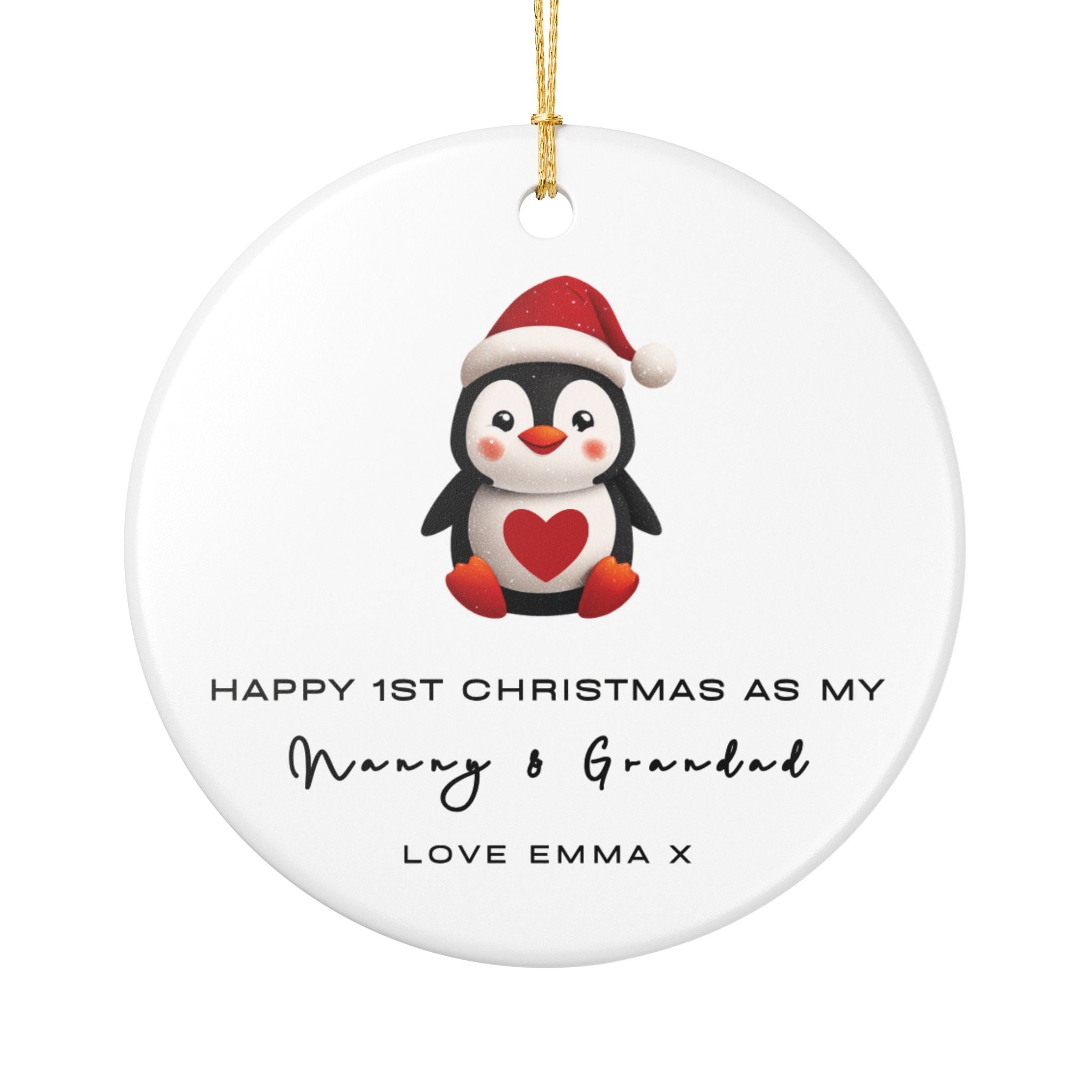 A round ceramic Christmas ornament featuring an illustrated penguin wearing a Santa hat. It displays custom text that begins, "Happy 1st Christmas as My," followed by a personalised grandparent title, name and custom message.