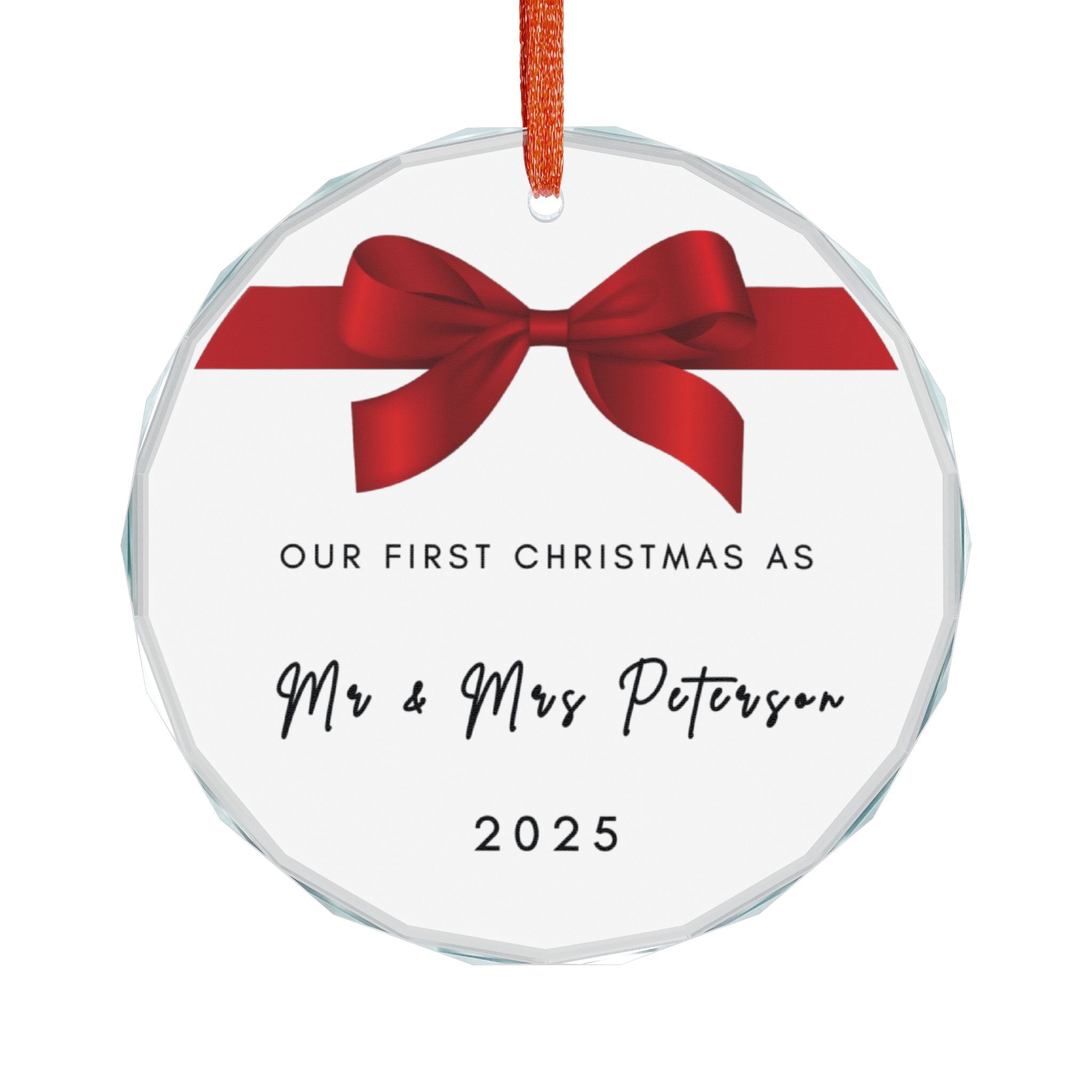 Round crystal glass Christmas ornament featuring a red bow and the text "Our First Christmas As Mr & Mrs" followed by a personalised surname and the year.