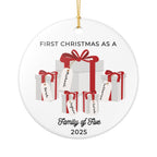Round, white ceramic Christmas ornament. It features a vivid illustration of a stack of colorful wrapped presents, each secured with a ribbon. The names of family members are personalised and printed on a label in the front of each gift box. The main commemorative text, 'First Christmas as a Family of Five' and the year (e.g., 2025), is centered at the bottom of the ornament.