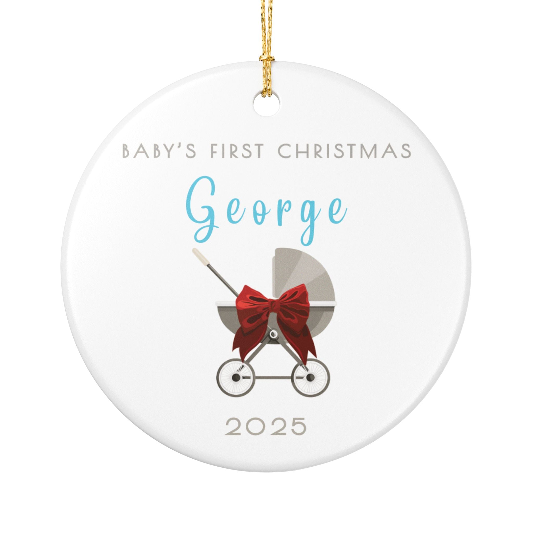 Round ceramic Christmas ornament featuring a baby carriage (pram) design accented with a red bow. Personalised text includes the baby's name, the year, and the phrase "Baby's First Christmas".  White background.