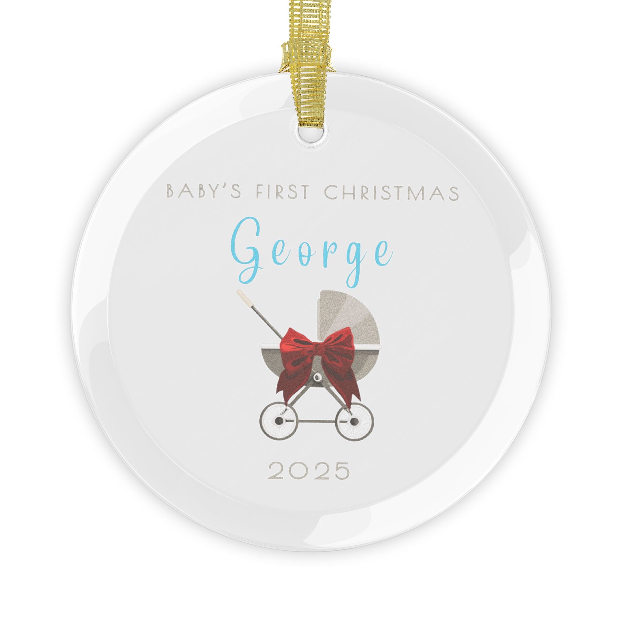 Round glass Christmas ornament featuring a baby carriage (pram) design accented with a red bow. Personalised text includes the baby's name, the year, and the phrase "Baby's First Christmas".  