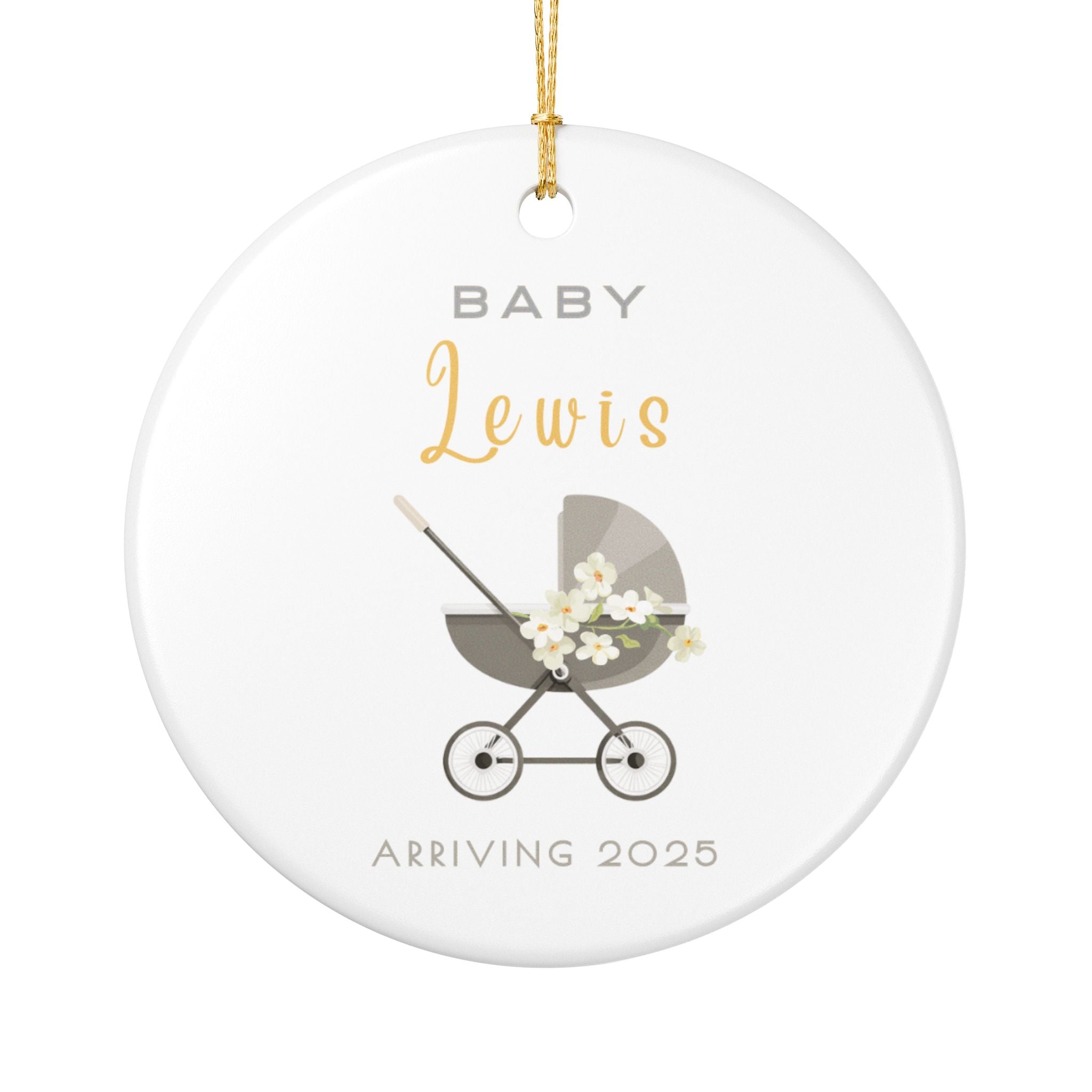 Round ceramic Christmas ornament featuring a baby carriage (pram) design accented with small flowers. Personalised text includes the baby's name, the year, and the phrases "Baby" and "Arriving." White background.