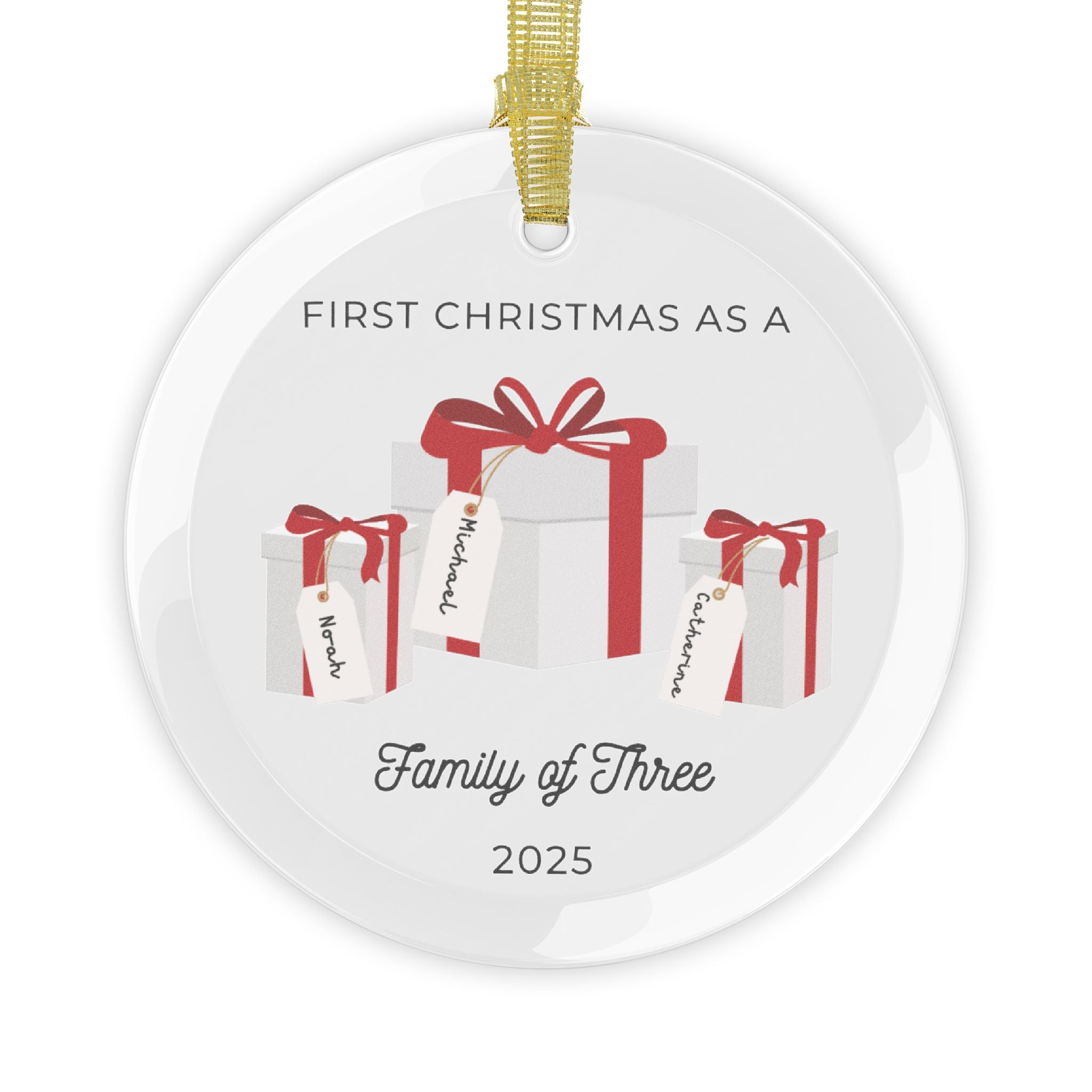 Round, glass Christmas ornament. It features a vivid illustration of a stack of colorful wrapped presents, each secured with a ribbon. The names of family members are personalised and printed on a label in the front of each gift box. The main commemorative text, 'First Christmas as a Family of Three' and the year (e.g., 2025), is centered at the bottom of the ornament.