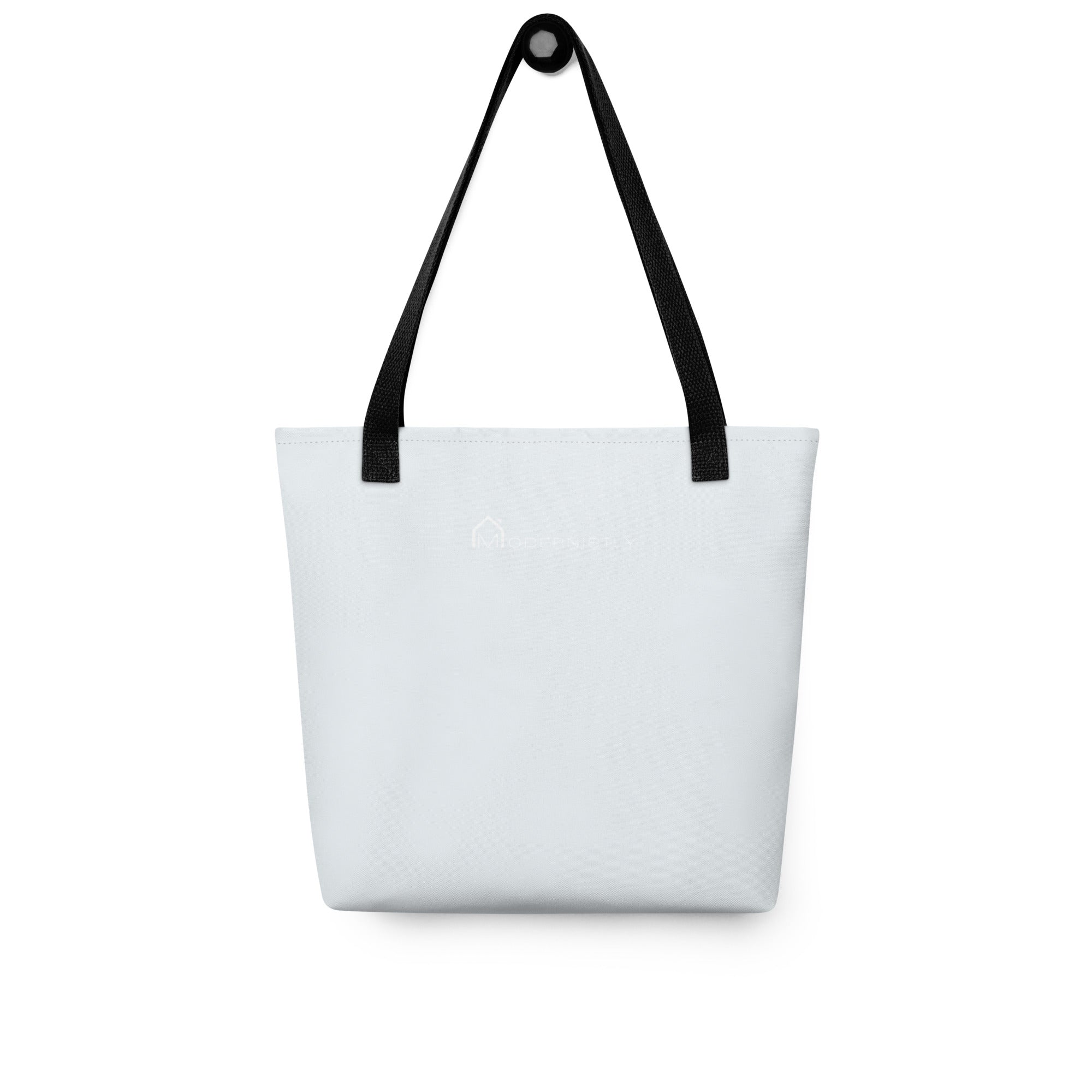 Rear view of a blue tote bag with black handles featuring the MODERNISTLY logo in white.
