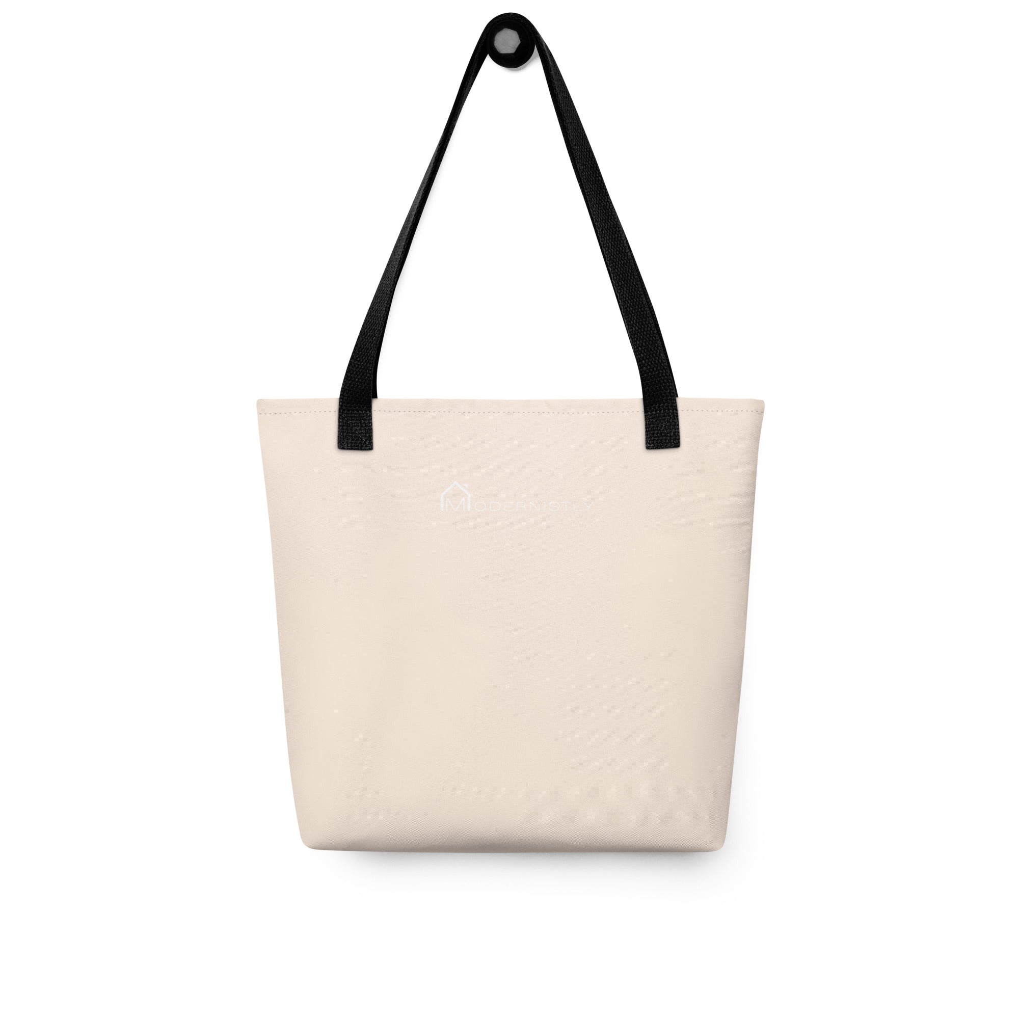 Rear view of a light orange tote bag with black handles featuring the MODERNISTLY logo in white.