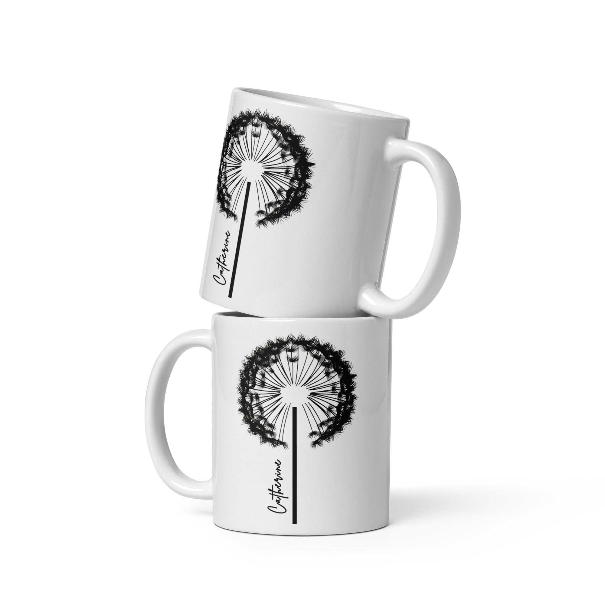 White glossy ceramic mug with a delicate black dandelion design and a custom name printed on the front. 11oz personalised coffee cup, ideal for tea, coffee, or hot chocolate lovers.