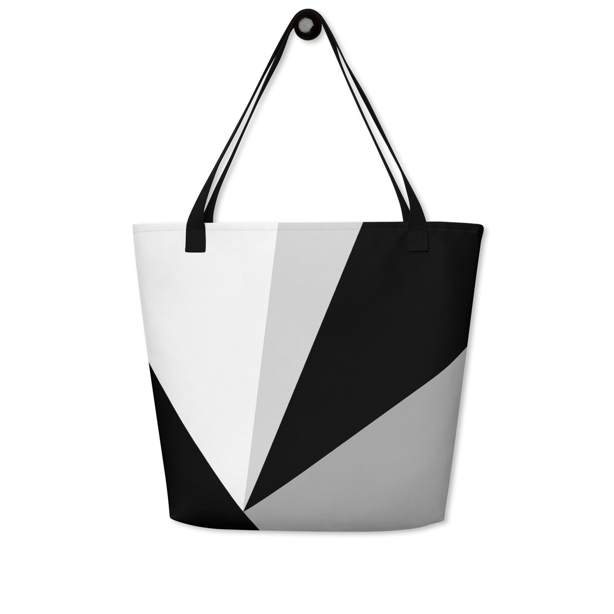 Front view of a large tote bag with black handles and a black, grey, and white geometric pattern.