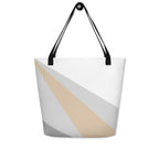 Back view of a large tote bag with black handles and a beige, grey, and white geometric pattern.