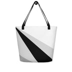 Back view of a large tote bag with black handles and a black, grey, and white geometric pattern.
