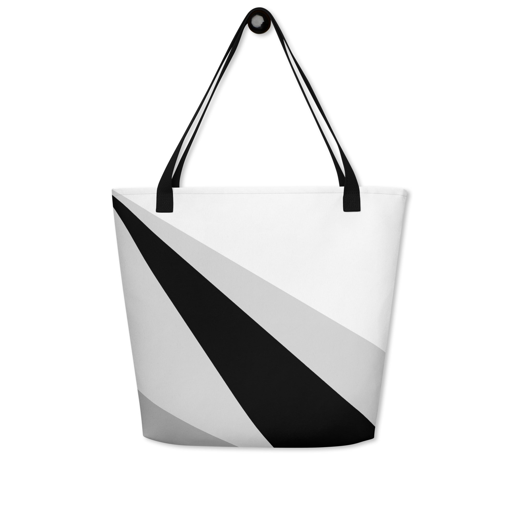 Back view of a large tote bag with black handles and a black, grey, and white geometric pattern.