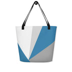 Front view of a large tote bag with black handles and a blue, grey, and white geometric pattern.