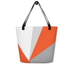 Front view of a large tote bag with black handles and an orange, grey, and white geometric pattern.