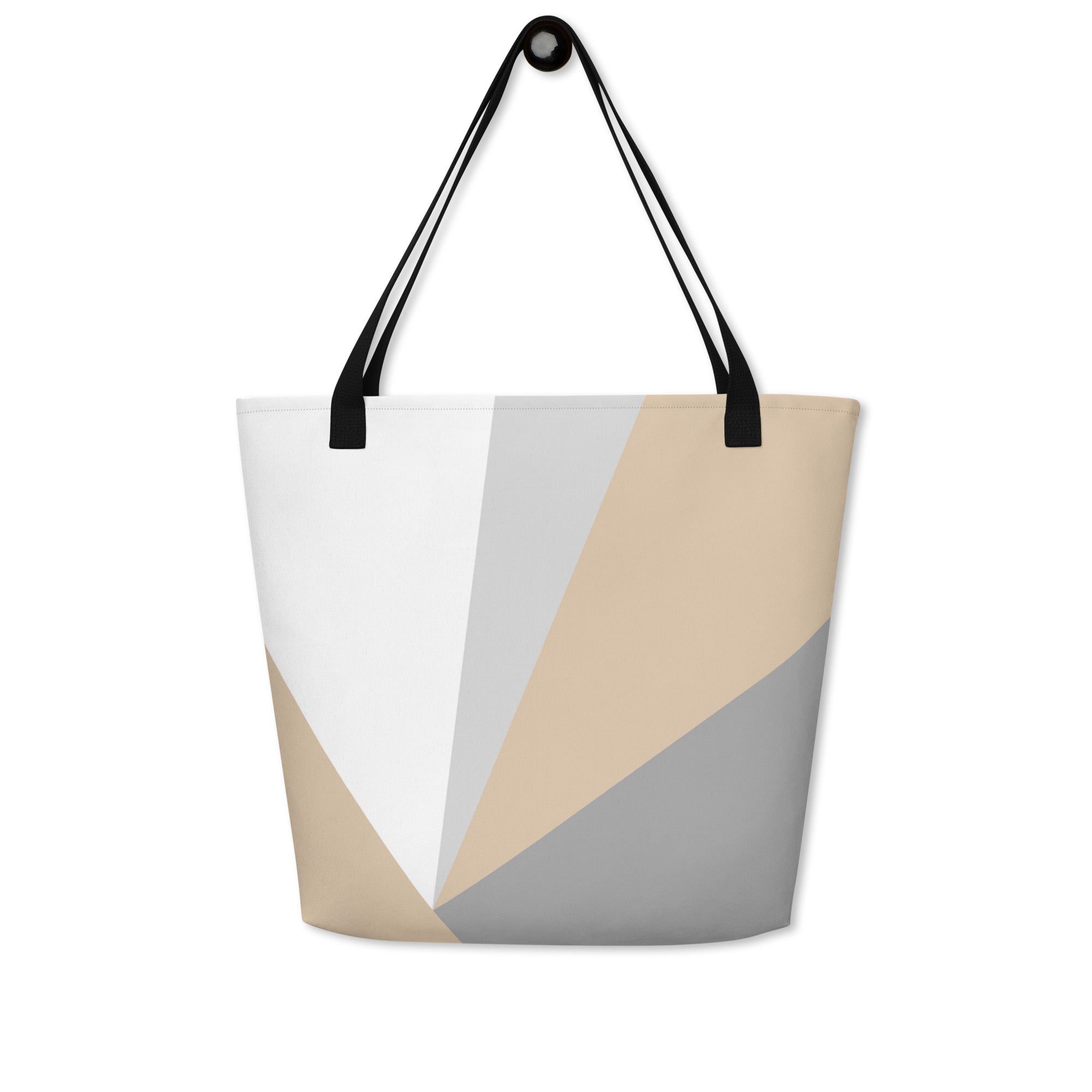 Front view of a large tote bag with black handles and a beige, grey, and white geometric pattern.