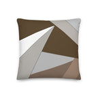 Front view of a cushion with geometric pattern made of triangles in shades of brown, grey, sand and white.