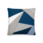 Front view of a cushion with geometric pattern made of triangles in shades of blue, grey, sand and white.