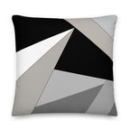 Front view of a cushion with geometric pattern made of triangles in shades of black, grey, sand and white.