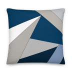 Front view of a cushion with geometric pattern made of triangles in shades of blue, grey, sand and white.