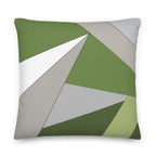 Front view of a cushion with geometric pattern made of triangles in shades of green, grey, sand and white.