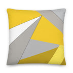 Front view of a cushion with geometric pattern made of triangles in shades of yellow, grey, sand and white.