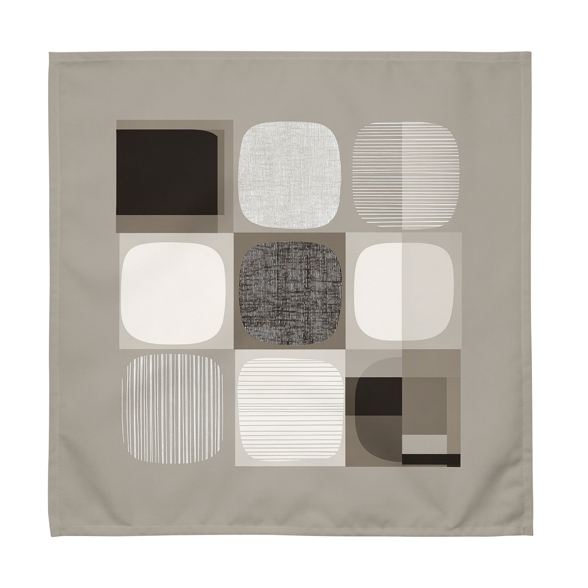 Sand-coloured cloth napkin featuring an abstract geometric pattern of circles and squares in brown, light and taupe colours.
