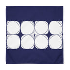 Blue cloth napkin featuring an abstract pattern of eight white circles arranged in two rows.