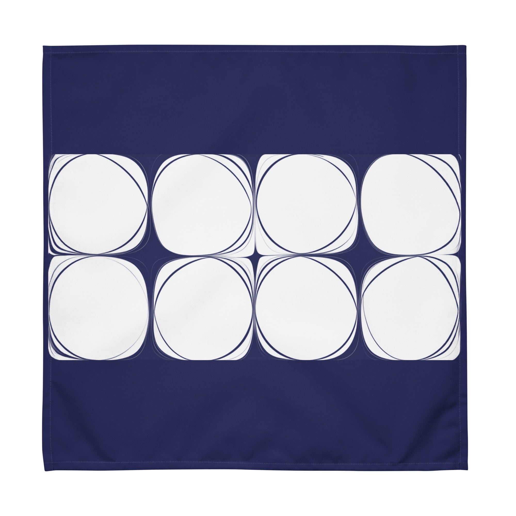 Blue cloth napkin featuring an abstract pattern of eight white circles arranged in two rows.