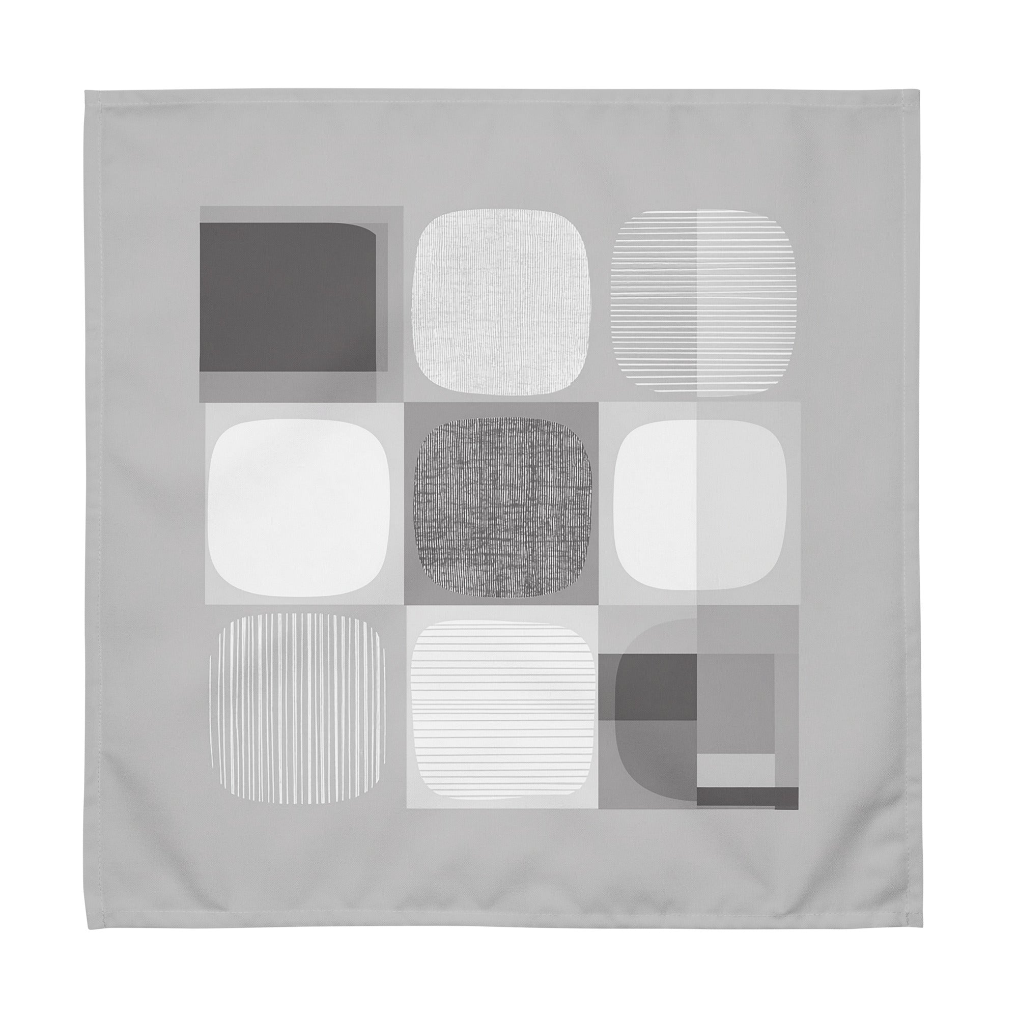 Grey-coloured cloth napkin featuring an abstract geometric pattern of circles and squares in grey and light colours.