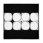 Black cloth napkin featuring an abstract pattern of eight white circles arranged in two rows.