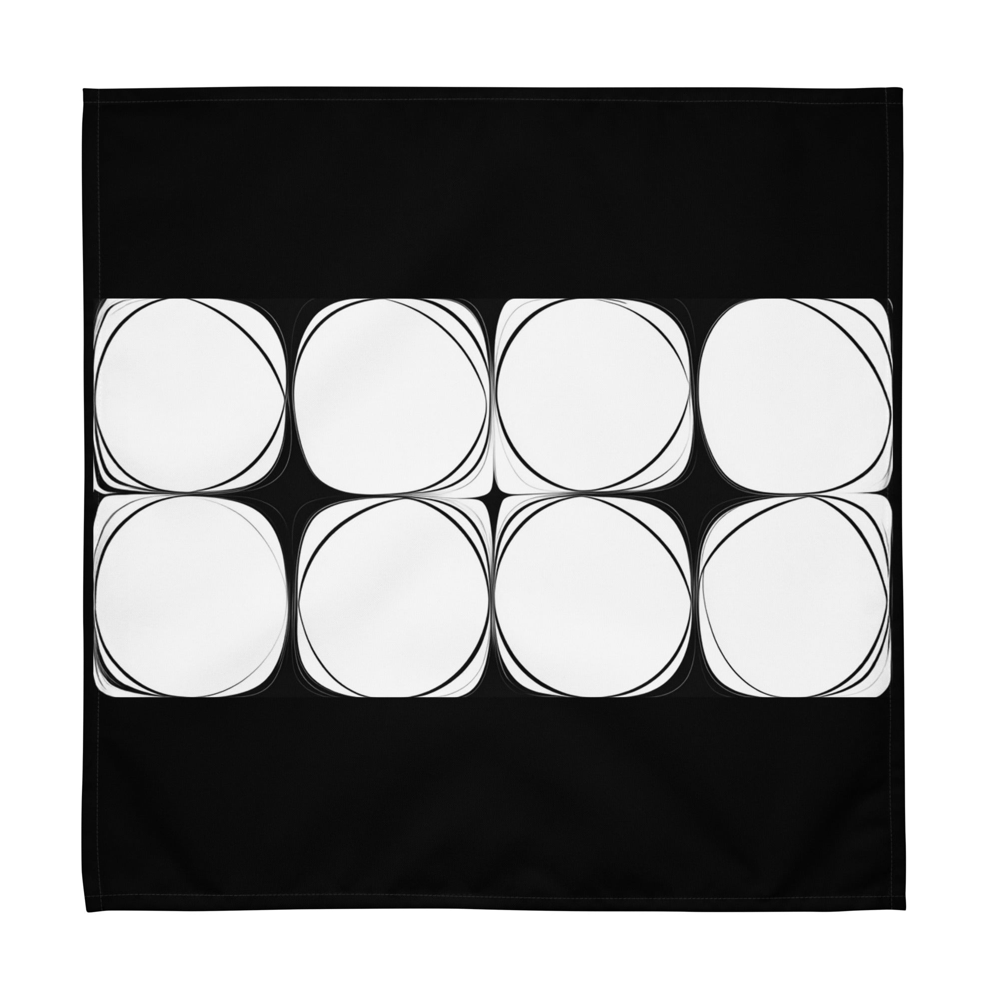Black cloth napkin featuring an abstract pattern of eight white circles arranged in two rows.