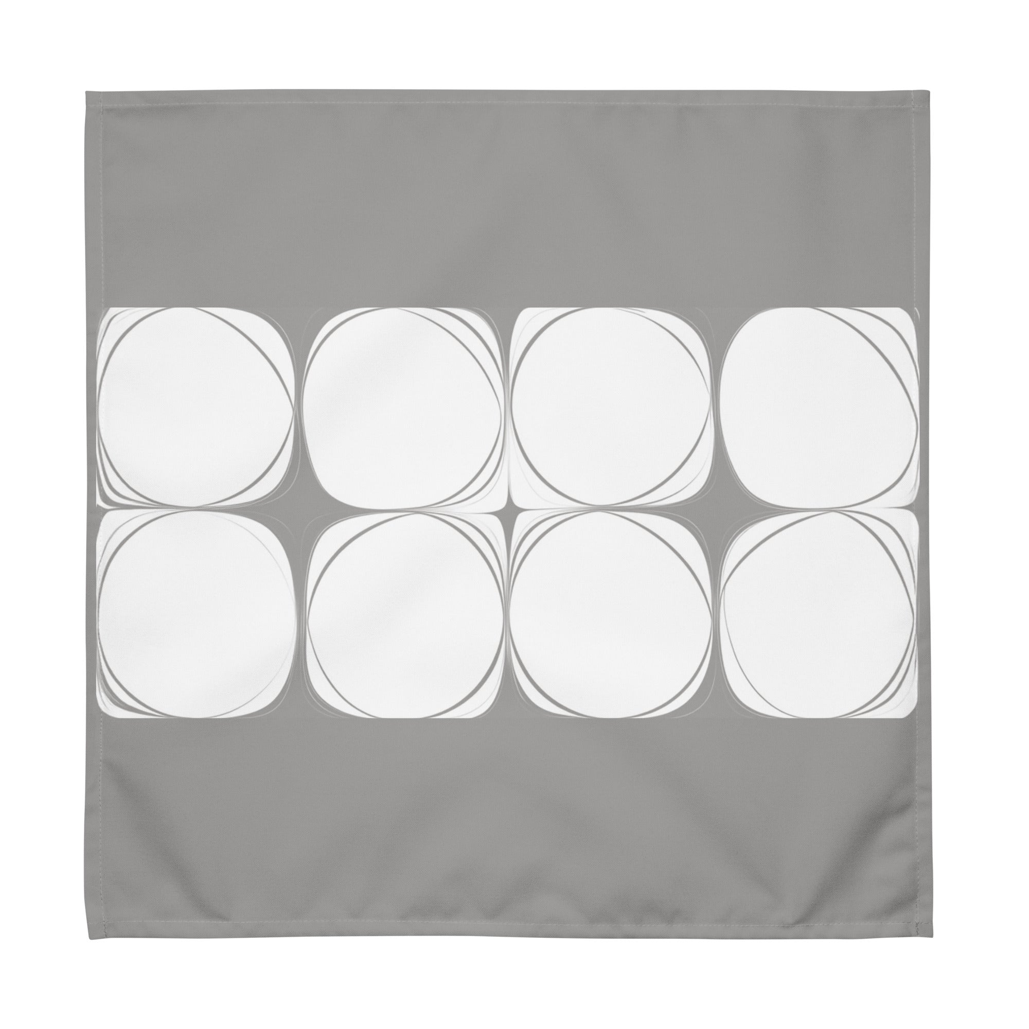 Grey cloth napkin featuring an abstract pattern of eight white circles arranged in two rows.