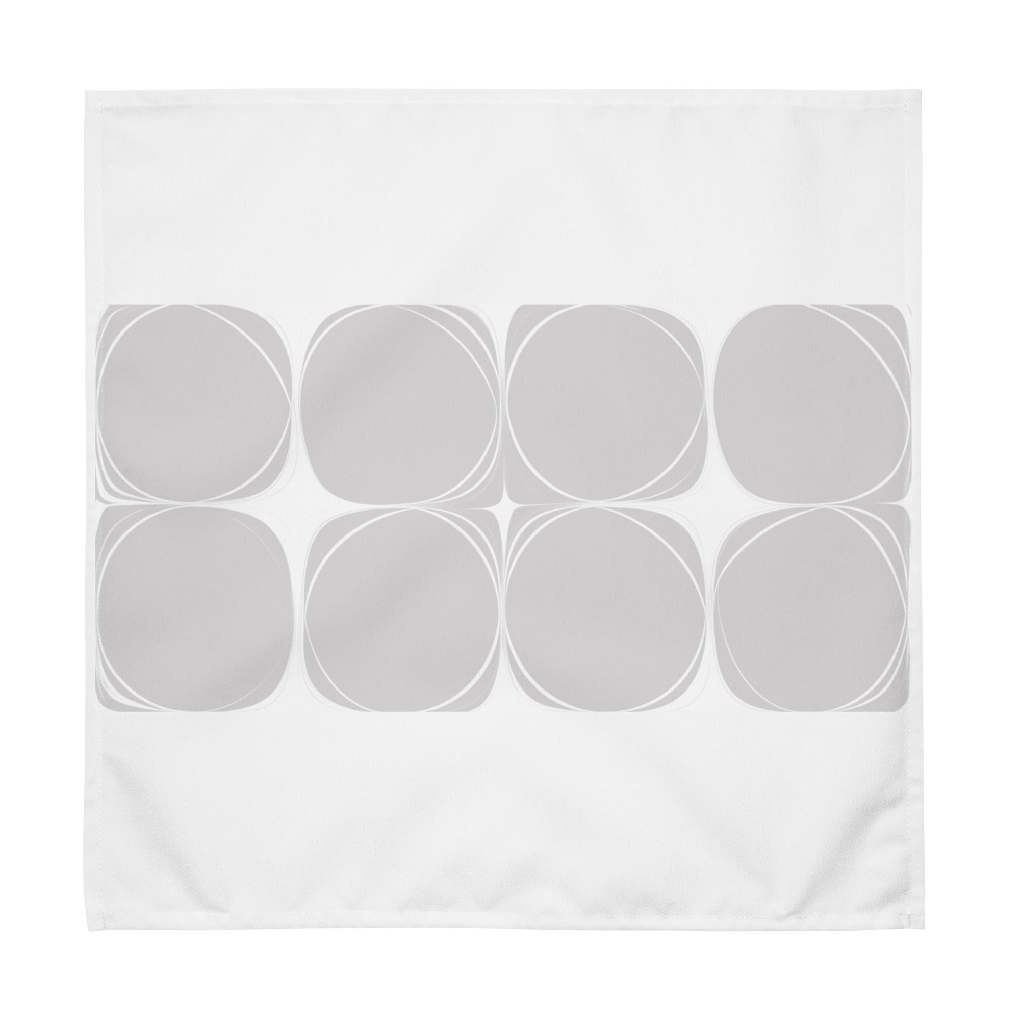 White cloth napkin featuring an abstract pattern of eight grey circles arranged in two rows.