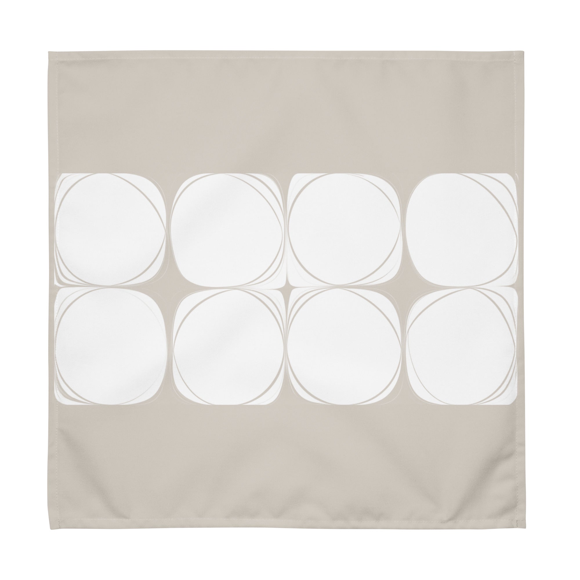 Sand coloured cloth napkin featuring an abstract pattern of eight white circles arranged in two rows.