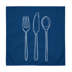 Blue cloth napkin with a detailed white drawing of a fork, knife, and spoon stacked vertically down the center.