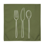 Green cloth napkin with a detailed white drawing of a fork, knife, and spoon stacked vertically down the center.
